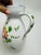 This is a hand-painted Italian ceramic pitcher marked “The Ivy – Italy” on the base. It features a white glazed body with...
