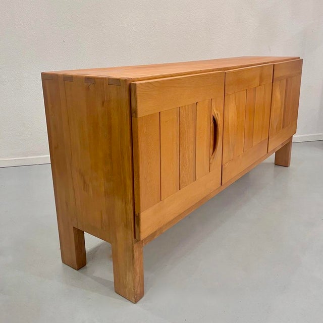 Sideboard in Elm from Maison Regain, France, 1970, in Good conditions. Designed 1970 to 1979 This piece is attributed to...