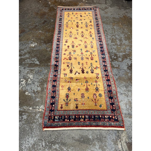 Design Plus Gallery presents a 3ft 2 in × 9ft 4 in Persian-Style Wool Runner Rug. This wool runner has a golden field with...