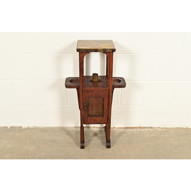 A beautiful antique Mission or Arts & Crafts period oak and brass smoker stand In the manner of Stickley Brothers By The...