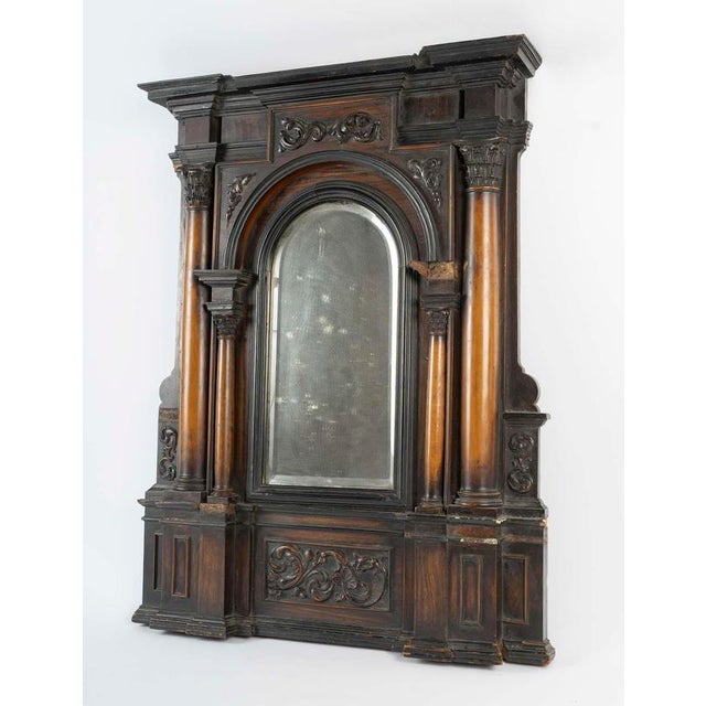 Mirror from the XVIIth century in carved wood, colonnaded decorations, beveled mirror, (bag of small elements to glue). H:...