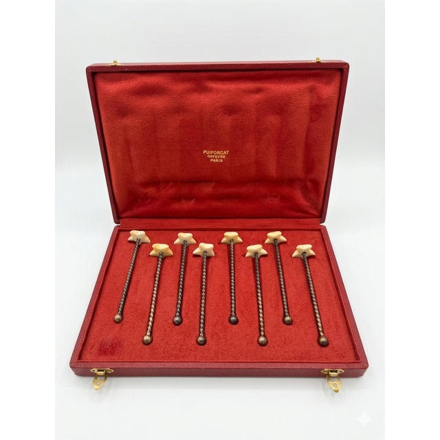 This museum-grade octet perfectly exemplifies the geometric avant-garde aesthetic pioneered by Jean Puiforcat during the...