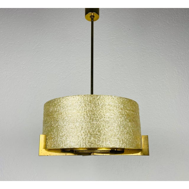 Rare brass chandelier made in Germany in the 1960s. It is fascinating with its extraordinary acrylic glass shade and brass...