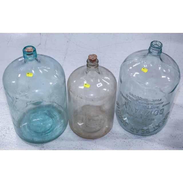 Vintage Set of Three Hand Blown Glass Demijohns. The largest demijohn features embossed Great Bear Spring Co.. Dimension...
