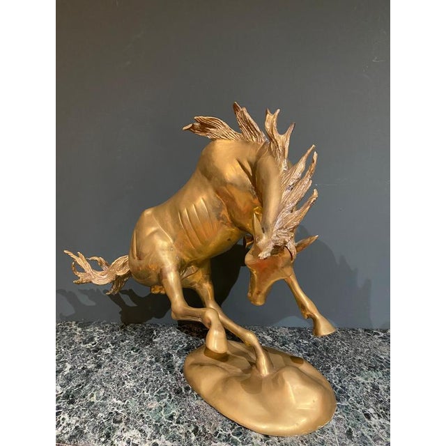 A beautifully detailed Italian brass sculpture of a stallion in motion.
