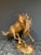 A beautifully detailed Italian brass sculpture of a stallion in motion.
