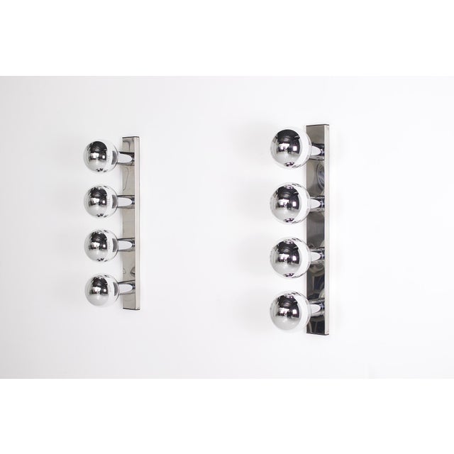 Pair of wall sconces designed by motoko ishii and produced by staff leuchten in the late 1960s. the brackets are made of...