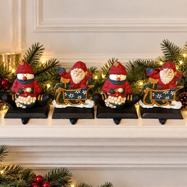 Believed to date from the 1990s, this substantial set of four cast iron Christmas stocking holders features two Santa...