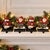 Believed to date from the 1990s, this substantial set of four cast iron Christmas stocking holders features two Santa...