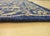 A hand-knotted wool rug, made in India and measuring 6' x 9'. Floral drawing carried across the field inside a traditional...