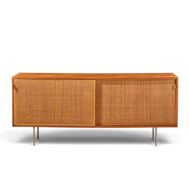 Florence Knoll for Knoll Model 116 Mid Century Walnut and Cane Sliding Door Credenza This credenza measures: 72 wide x 18...