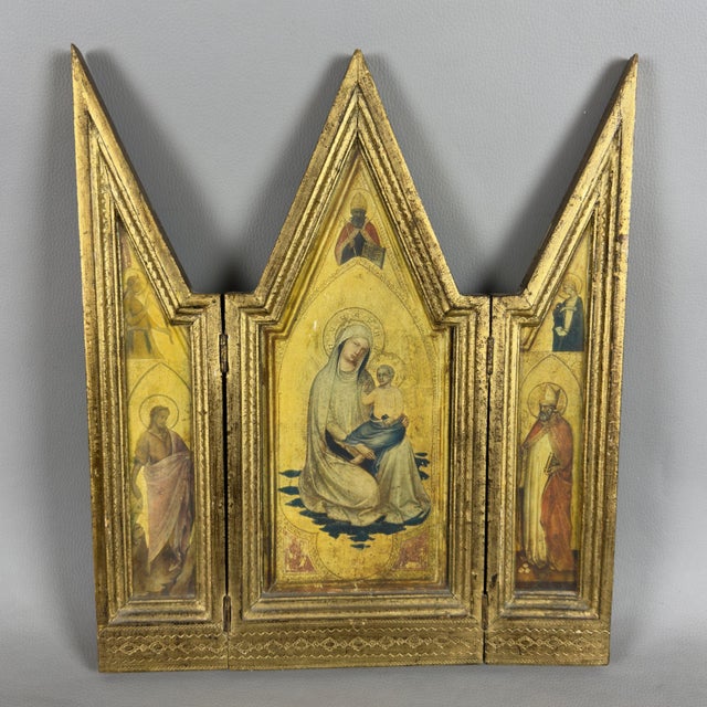 An elegant and evocative gilded wooden triptych table altar with folding doors, featuring a fine silkscreen print on a...
