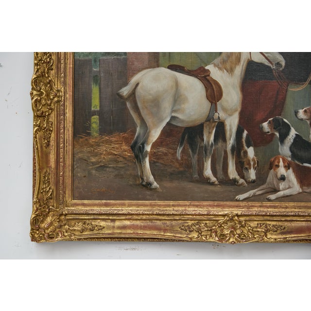 An English oil on canvas painting signed C. Goddard, depicting a horse and hound dogs. This English oil on canvas...