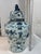 This striking 25" blue and white Asian temple jar features hand-painted yin-yang symbols, peonies and sacred Buddhist...
