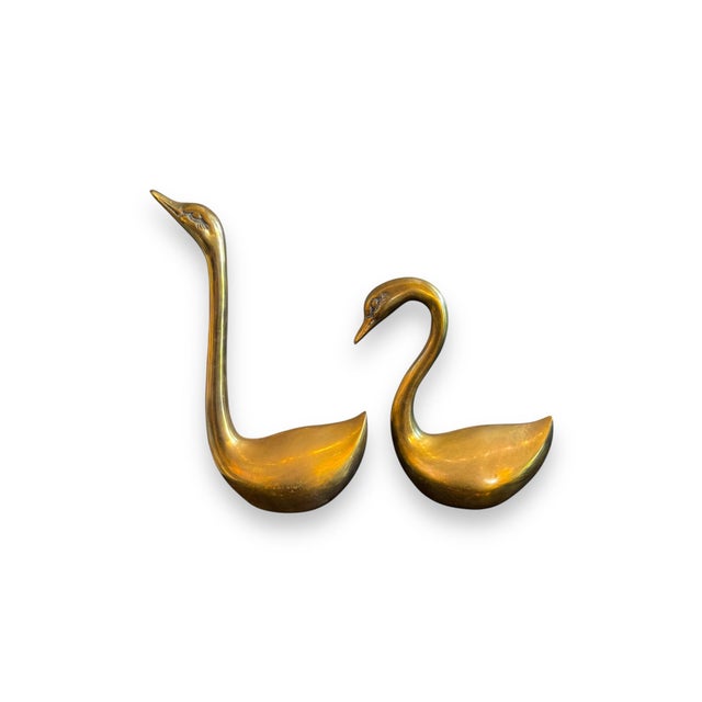 Graceful and timeless, this preloved set of two brass swans makes a striking decorative accent. With their elegant lines...