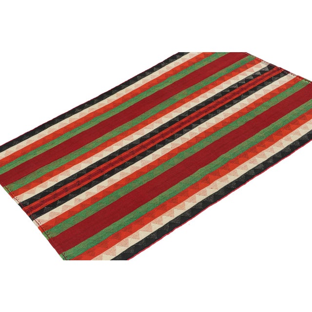 This vintage 5x7 Persian kilim rug is handwoven in wool, and originates circa 1950-1960. Its design is a panel-weave, in...