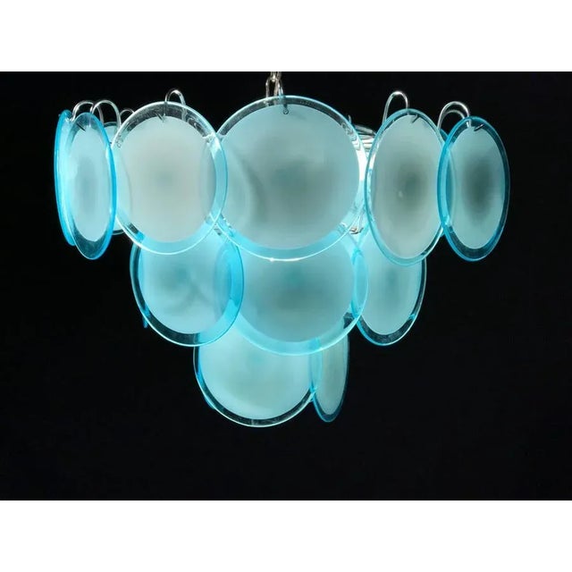 The rare 24 turquoise discs of precious Murano glass are arranged on floor levels. Nine E14 light bulbs. Measures: Height...