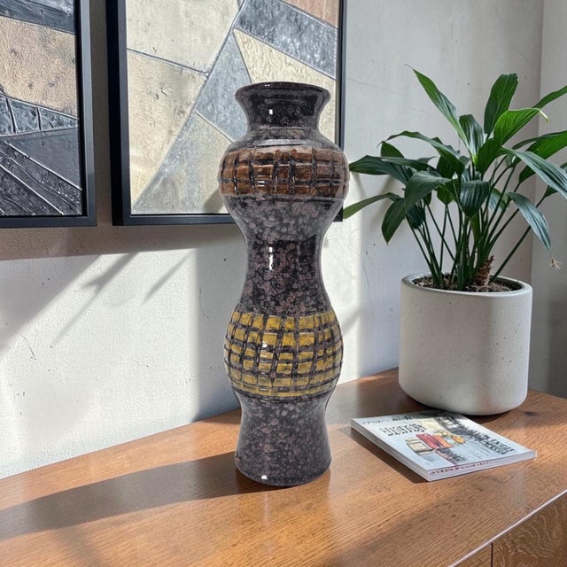 This vintage Italian studio pottery vase was produced during the mid-twentieth century and is attributed to an Italian...