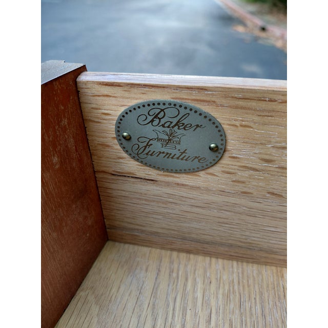Handsome vintage bachelor’s chest by Baker Furniture, featuring a gracefully bowed front and rich mahogany-toned finish....