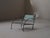 Low lounge chair, handcrafted in France around 1960, It is made from hammered wrought iron and folded steel sheet. Its...
