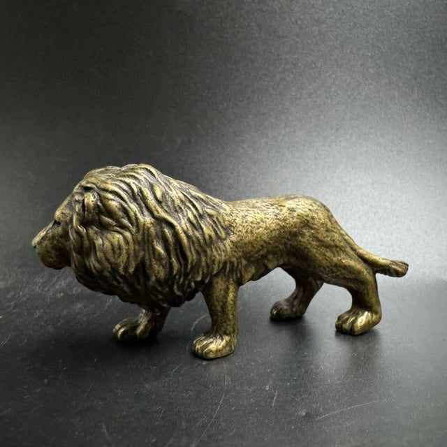This finely detailed solid brass lion figurine brings a touch of the wild to your desk or shelf. The lion is depicted in a...