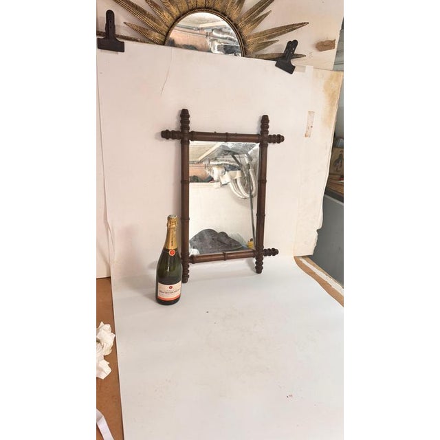 Carved Wooden Mirror — France, 1940s : This elegant carved wooden mirror was made in France in the 1940s. Its warm brown...