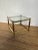 Vintage Mastercraft style brass and glass side table featuring square lines, fluted wood leg insets, and a single glass...