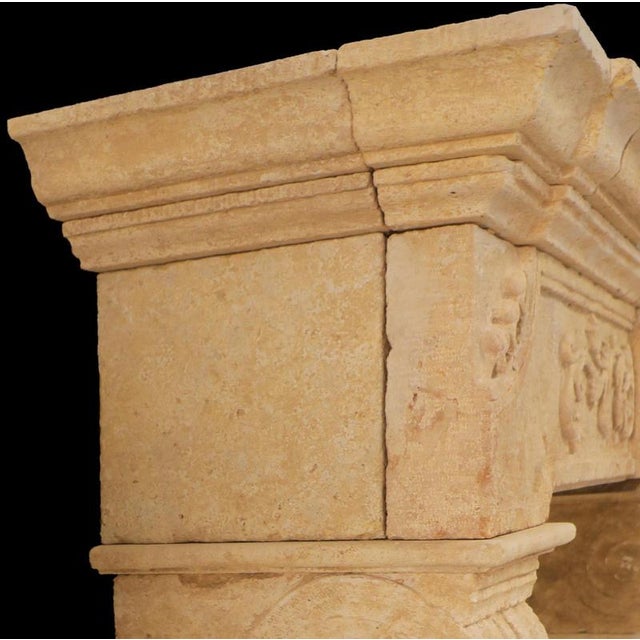 A striking example of classical European design, this 20th-century limestone fireplace mantle combines architectural...