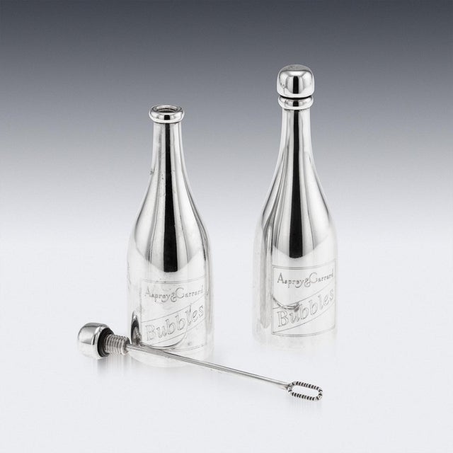 Vintage 21st century solid silver "champagne bottle" bubble blowers, engraved with "asprey & garrard bubbles" on the...