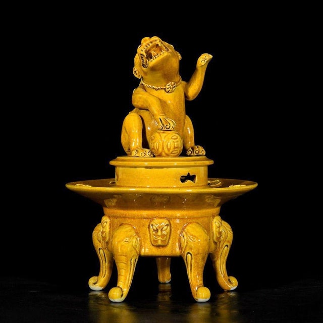 A striking Chinese yellow glazed porcelain censer (incense burner). The piece features a vibrant, deep yellow glaze with...