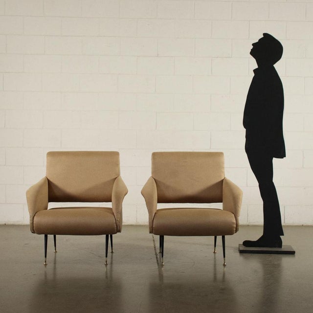 Pair of armchairs, foam padding, leatherette upholstery. This piece is attributed to the mentioned designer/maker. It has...