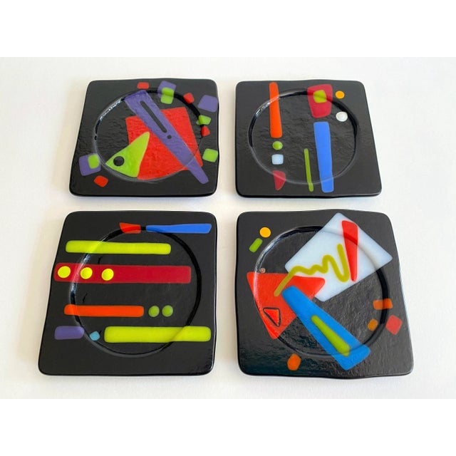 This set of four vintage 1980's Postmodern studio fused art glass multicolor Abstract coasters is a very special and...
