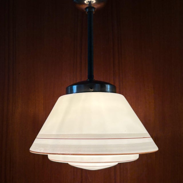 A Swedish Art Deco pendant lamp produced by an unidentified manufacturer in the 1930s. The fixture is constructed with a...