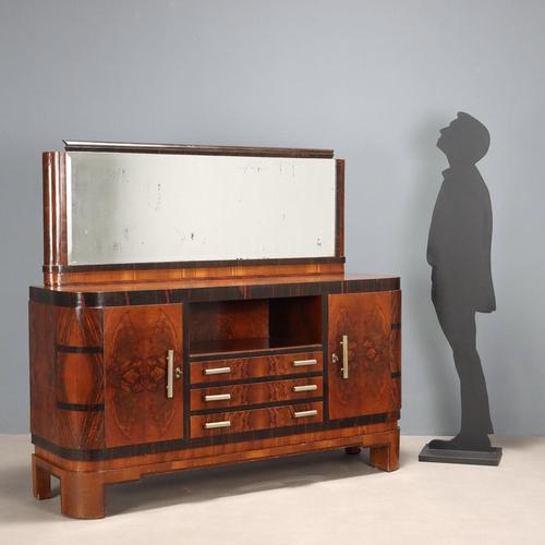 Art Deco cabinet with hinged doors, open compartment, and three drawers. It features a burl veneer with exotic wood...