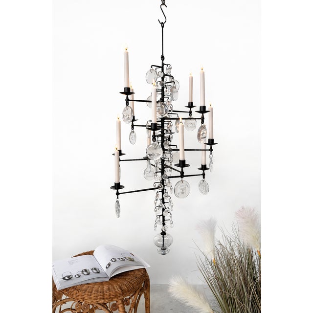This large high quality Swedish candle chandelier from the late 1960s was designed by the renown artist Erik Höglund. It...