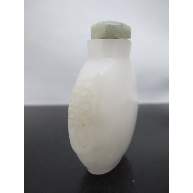 Chinese Carved Masks White Peking Glass Snuff Bottle With Green Top For Sale - Image 10 of 11