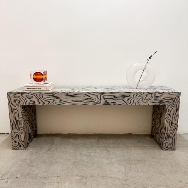A striking 1980s Postmodern console with a bold architectural form and sculptural presence. The elongated rectangular top...
