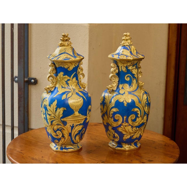 A striking pair of English Mason’s Ironstone lidded vases dating to circa 1840, richly decorated in cobalt blue and gilt....