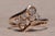 The Sutton Place: Antique Rose Gold Bypass Style Lucky Clover Diamond Ring. The ring centers on two three-leaf clovers...