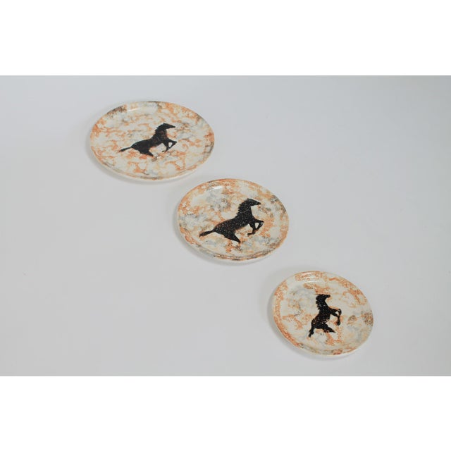 Set of three vintage equestrian studio art pottery plates. Each is signed by artist and dated. No chips or cracks. These...