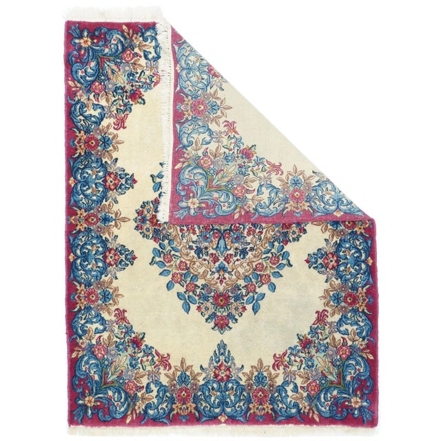 The straw-ivory open field of this SE Persian urban scatter shows a complex floral medallion with and innermost light blue...