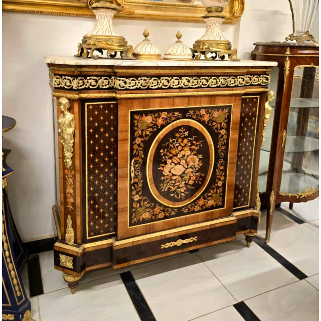 Elevate your home with this magnificent French Louis XVI cabinet, a masterpiece of traditional European craftsmanship....