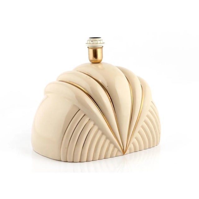 Italian cream-colored ceramic table lamp with gold decoration signed by Paolo Traversi in the 1980s. Signed This piece has...