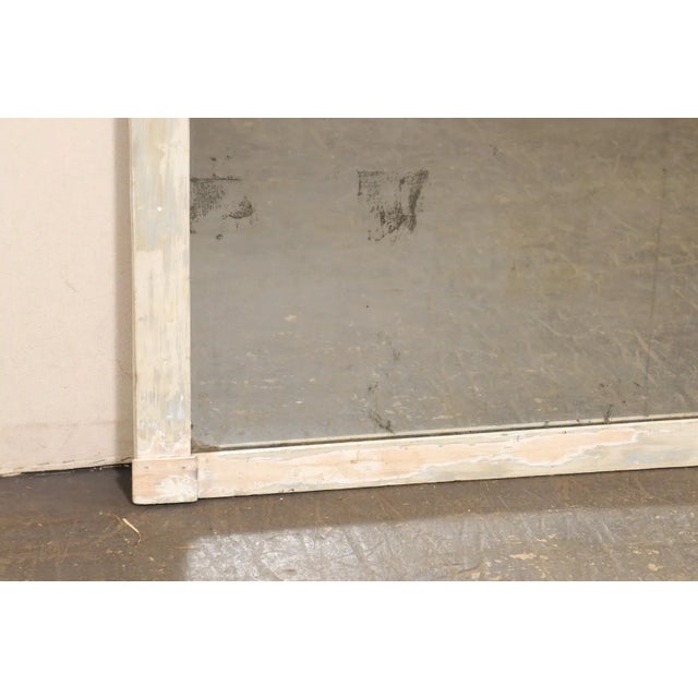 A French painted wood mirror, with its original 2-piece glass, from the 19th century. This antique mirror from France...