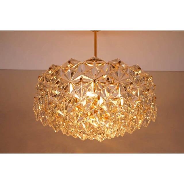 A large five tier gilt kinkeldey chandelier with hexagonal crystals. The chandelier was manufactured by kinkeldey in...