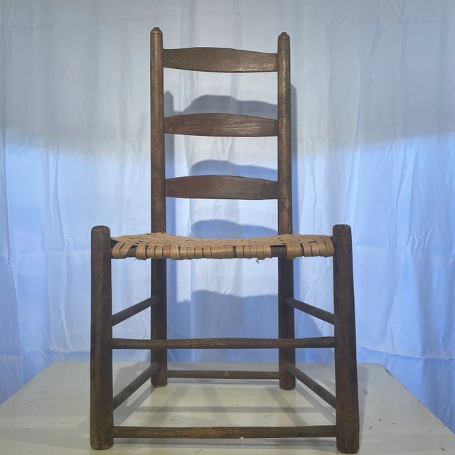 Three slat ladder back chair. The seat appears to have been redone at some point. The finials at the top of the back look...