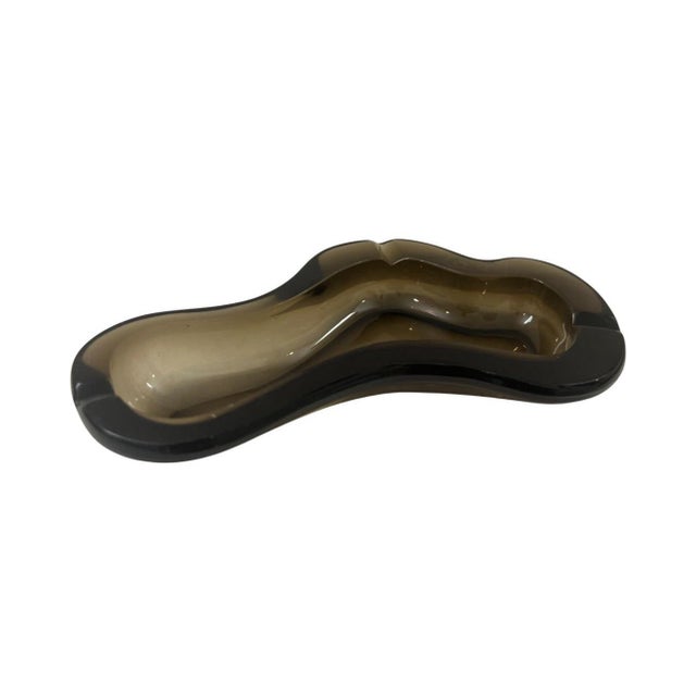 We have for your consideration a very gorgeous amoeba glass ashtray. Ashtray consists of an illuminating color of smoked...