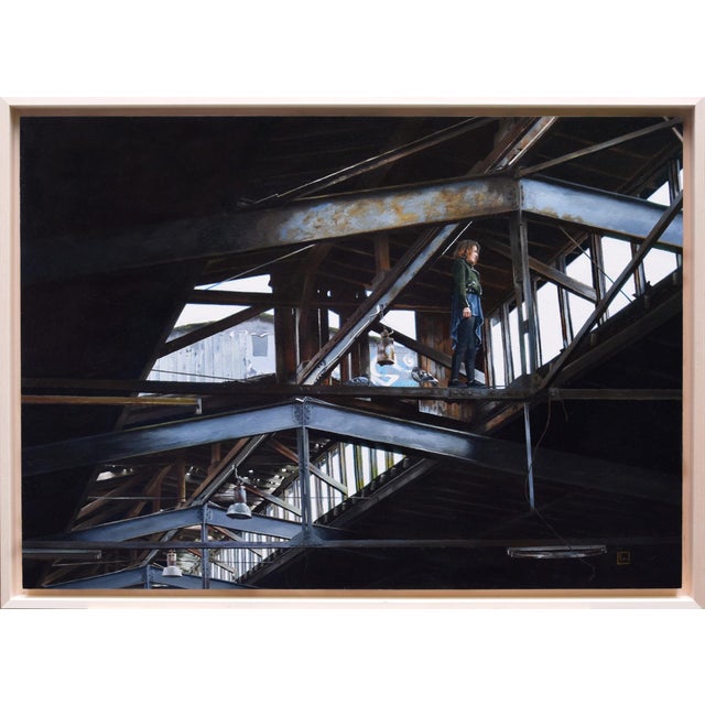 In "Seeking Solace," a solitary figure stands amidst the remnants of an industrial space, framed by the stark lines of...