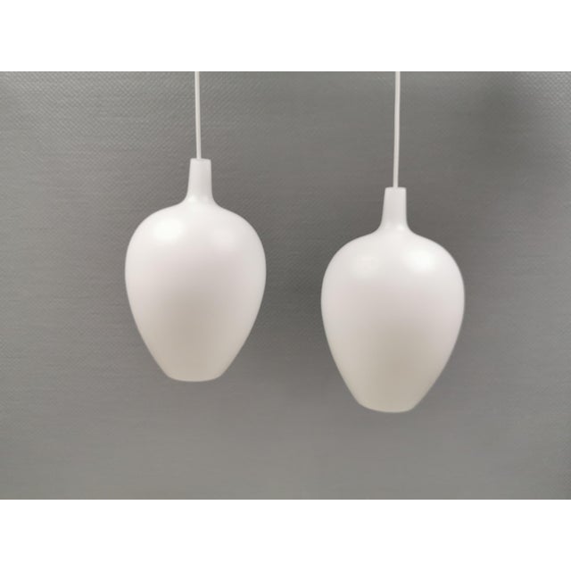 Two rare Pompei pendant lamps designed by Jo Hammerborg for Fog & Mørup in 1963. Made from double-layered glass (white on...