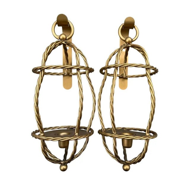 Striking vintage pair of Hollywood Regency-style gold rope candle lantern sconces. Each features an intricate twisted-rope...